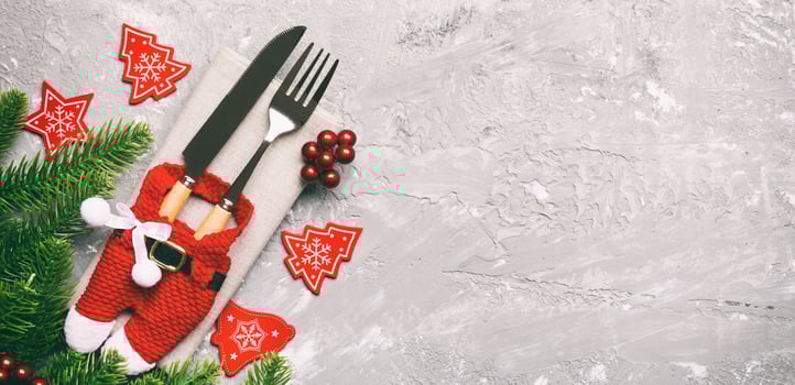 Top view Banner of festive cutlery on new year cement background. Christmas decorations with empty space for your design. Holiday dinner concept photo