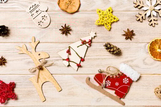 Top view of Christmas toys on wooden background. New Year ornament. Holiday concept photo