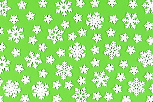 Set of white snowflakes on colorful background. Top view of Christmas ornament. New Year time concept with empty space for your design photo