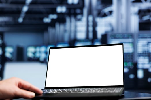 Close up shot of mock up laptop used by proficient repairman in data center using server cabinets to deliver massive computing power, control network resources, process and store datasets photo