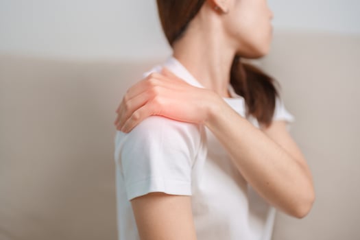 Woman having Shoulder and Neck pain during sitting on couch at home. Muscle painful due to Myofascial pain syndrome and Fibromyalgia, rheumatism, Scapular pain, Cervical Spine. ergonomic concept photo