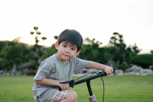 Asian boy playing bicycle in the park photo