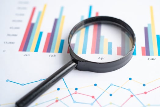 Magnifying glass on charts graphs paper. Financial development, Banking Account, Statistics, Investment Analytic research data economy. photo
