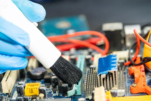 Asian technician repair and cleaning dirty micro circuit main board of smartphone electronic technology with brush, hardware, mobile phone, upgrade concept. photo