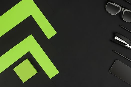 Top view of office supplies on blackboard background with copy space. photo