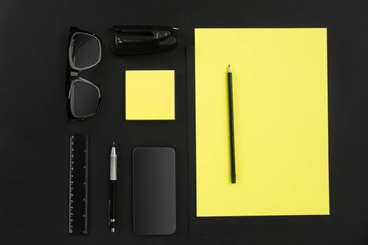 Top view of office supplies on blackboard background with copy space. photo