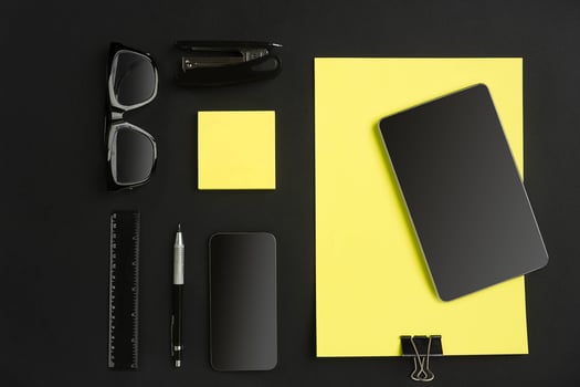 Top view of office supplies on blackboard background with copy space. photo