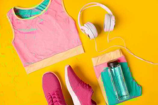 Sport equipment. Sneakers and bottle of water on yellow background photo