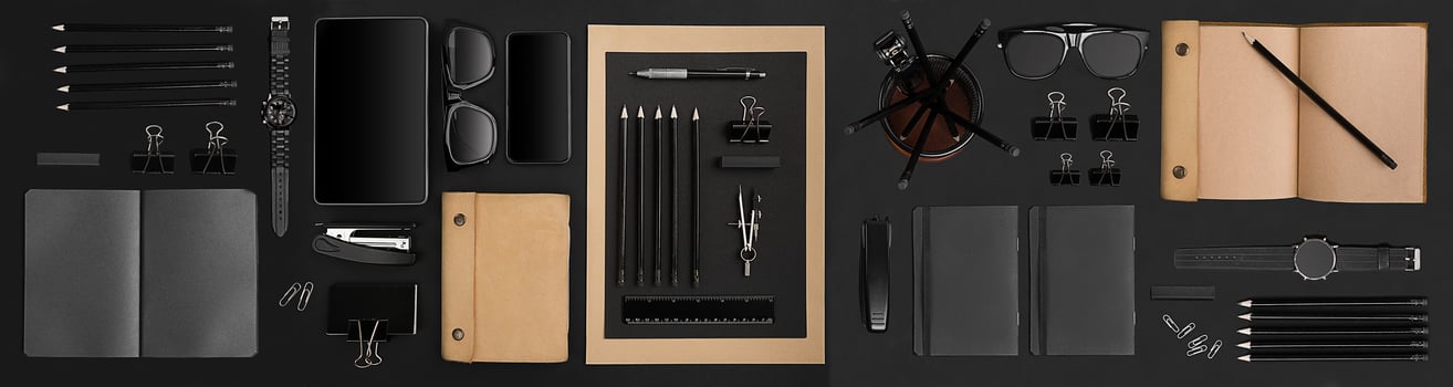 Office desktop with various black objects on background photo