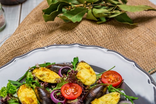 Fresh vegetable salad, healthy food, organic cucumbers, mussels, tomatoes and salad leaves photo