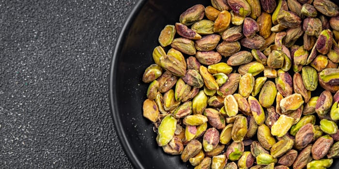 pistachios peeled nut healthy eating cooking appetizer meal food snack on the table copy space food background rustic top view photo