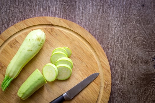 A sliced zucchini on a wooden board. Wooden background photo