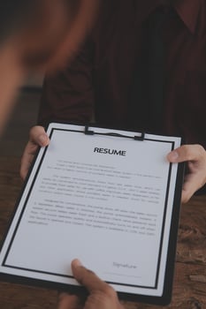 Close up view of job interview in office, focus on resume writing tips, employer reviewing good cv of prepared skilled applicant, recruiter considering application, hr manager making hiring decision photo