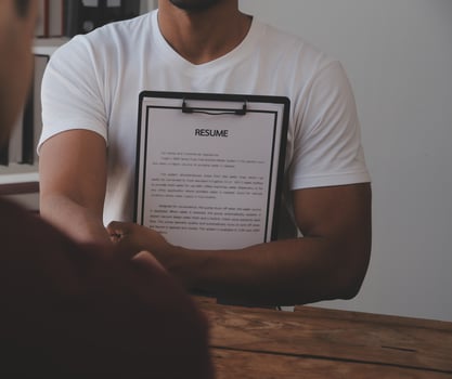 Close up view of job interview in office, focus on resume writing tips, employer reviewing good cv of prepared skilled applicant, recruiter considering application, hr manager making hiring decision photo