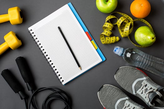 Workout plan with fitness food and equipment on gray background, top view photo