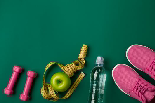 Workout plan with fitness food and equipment on green background, top view photo