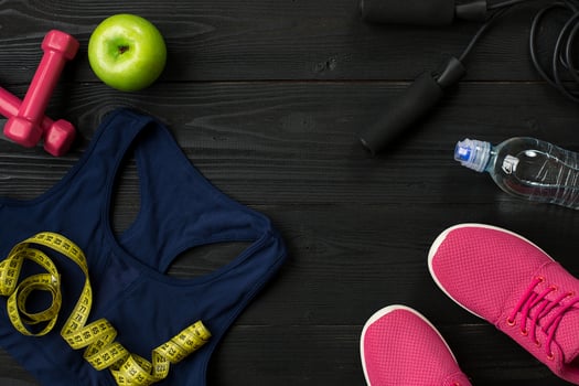 Workout plan with fitness food and equipment on dark background, top view photo