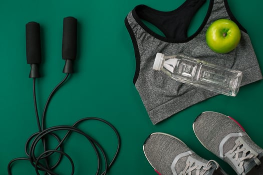 Sports accessories for fitness on the green floor. Healthy lifestyle concept. photo