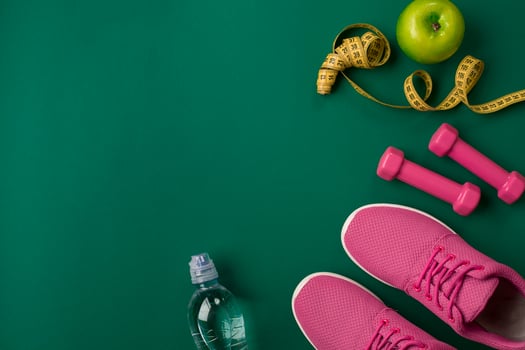 Workout plan with fitness food and equipment on green background, top view photo