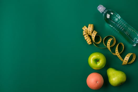 Workout plan with fitness food and equipment on green background, top view photo