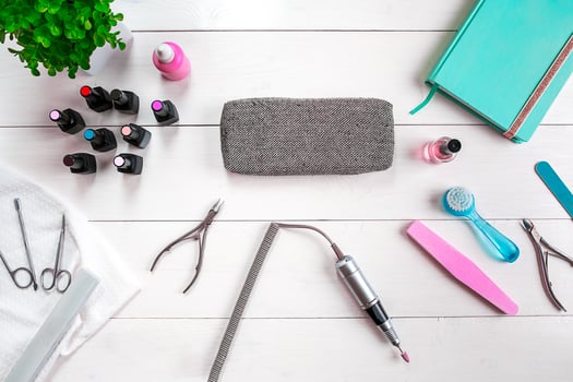 Manicure set and nail polish on wooden background photo