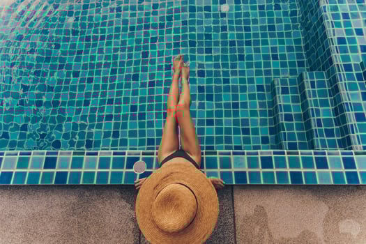 Gorgeous slim woman with perfect figure posing in swimming pool photo