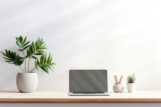 Minimalist simple office workspace with a laptop and a potted plant in soft natural light. Generative AI photo