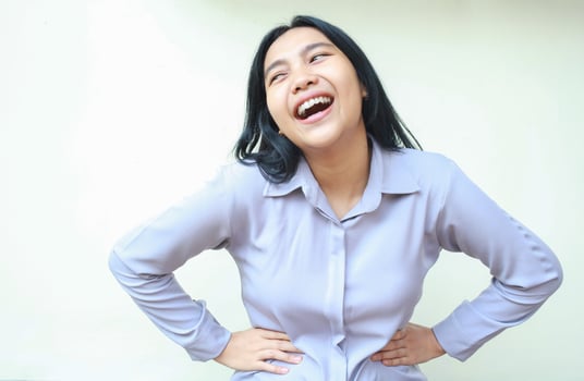 gorgeous asian business woman laughing happy with hand on waist celebrating big achievement look away rejoicing wear formal shirt standing over isolated white background photo