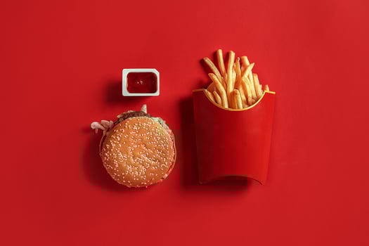 Burger and Chips. Hamburger and french fries in red paper box. Fast food on red background. photo
