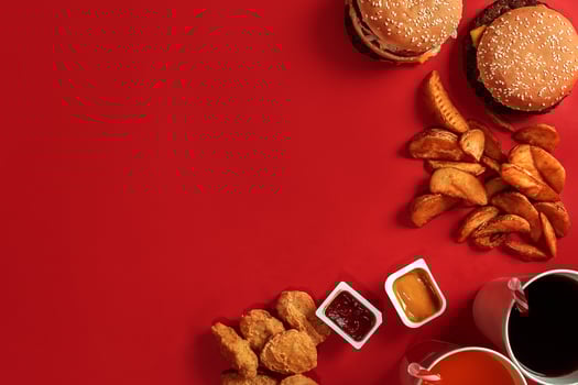Burger and Chips. Hamburger and french fries in red paper box. Fast food on red background. photo