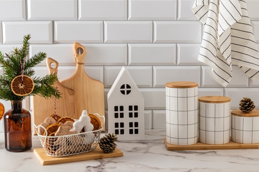Festive gingerbread with icing in vase on the kitchen countertop, decorated for the New Year with items made of natural materials. Eco-friendly photo