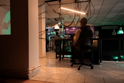 Mysterious spy planning security breach with virus, hacking computer server and breaking firewall encrytion. Male hacker working to steal government information late at night, cyberterrorism. photo