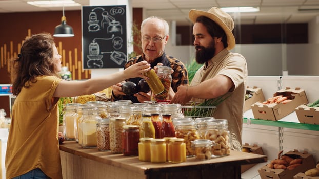 Sustainable zero waste supermarket ran by older storekeeper suggesting products to clients. Local neighborhood grocery store full with customers shopping for organic chemicals free produce photo