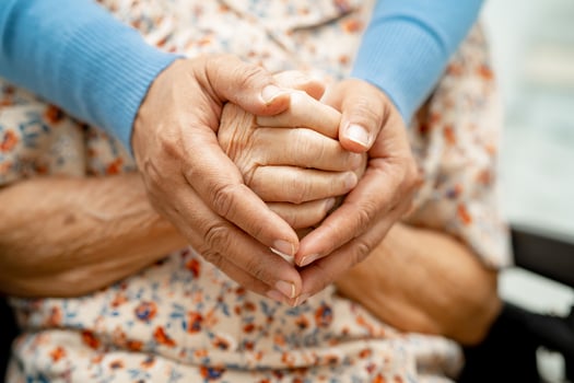 Caregiver holding hands Asian elderly woman patient with love, care, encourage and empathy at nursing hospital, healthy strong medical concept. photo