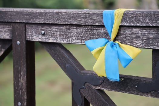 Ribbons in the colors of the national flag of Ukraine are tied to the handrail photo