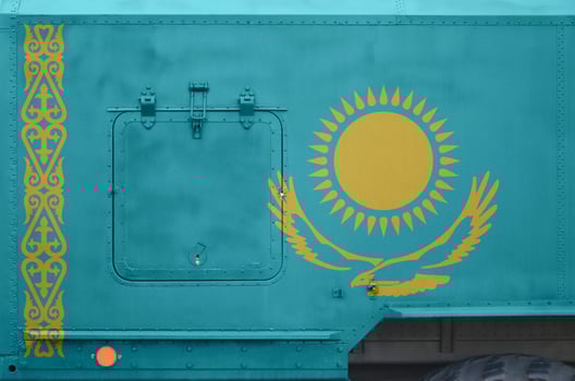Kazakhstan flag depicted on side part of military armored truck closeup. Army forces conceptual background photo