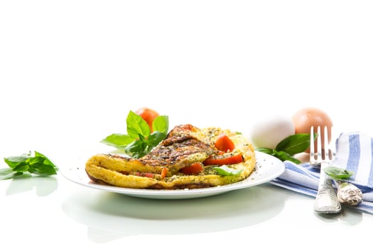 Stuffed omelette with tomatoes isolated on white background. photo