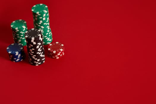 Poker chips on red background. Group of different poker chips. Casino background. photo