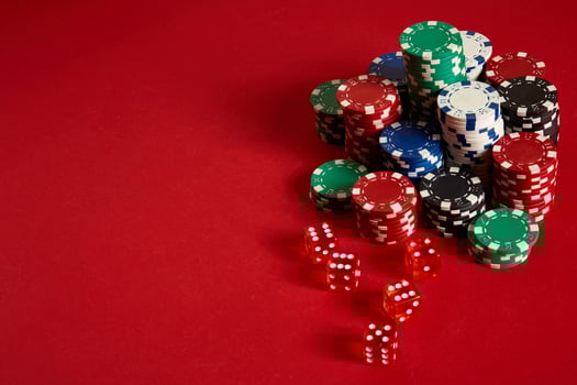 Poker chips on red background. Group of different poker chips. Casino background. photo