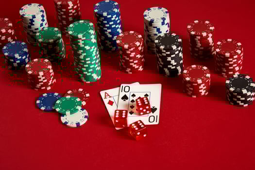 Poker cards and gambling chips on red background photo