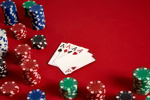 Poker cards and gambling chips on red background photo