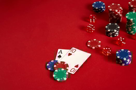 Poker cards and gambling chips on red background photo