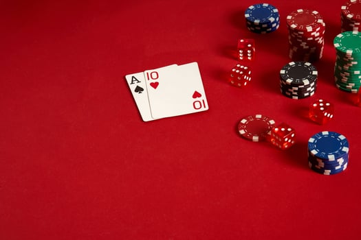Poker cards and gambling chips on red background photo