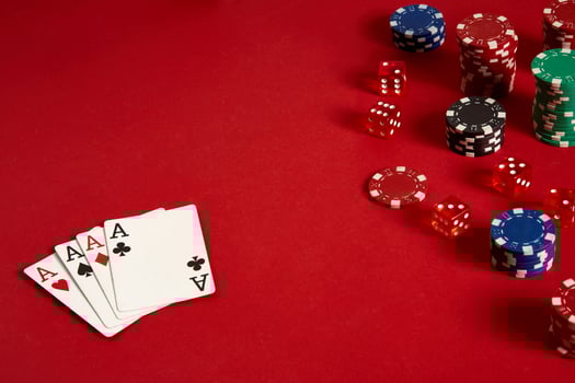 Poker cards and gambling chips on red background photo