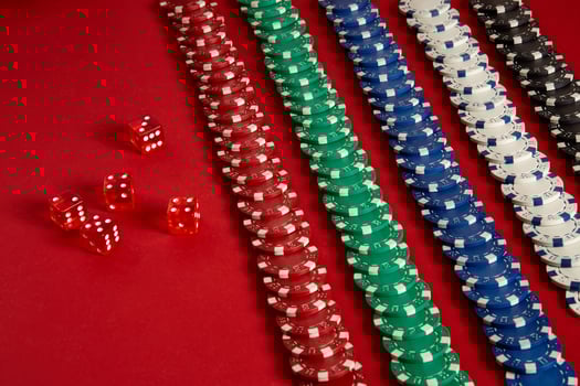 Stack of poker chips on red background at casino photo