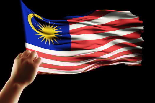 hand holding malaysia flag isolated on black background with clipping path, Hand waving Malaysia flag also known as Jalur Gemilang in conjunction, AI Generated photo