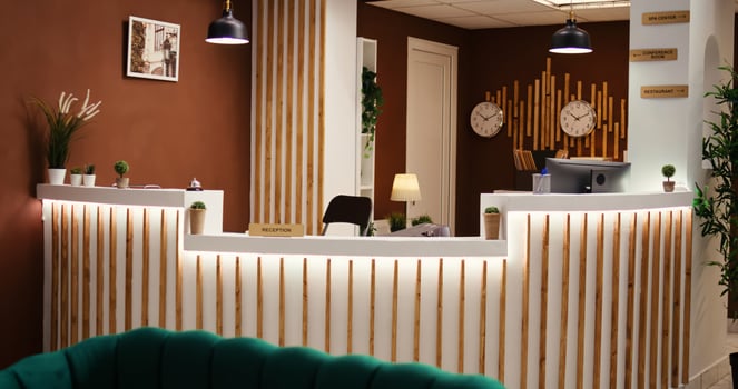 Jib up shot of empty stylish cozy travel vacation accommodation lobby interior with luxurious green furniture ready to welcome visitors. Hotel lounge with check in reception front desk photo