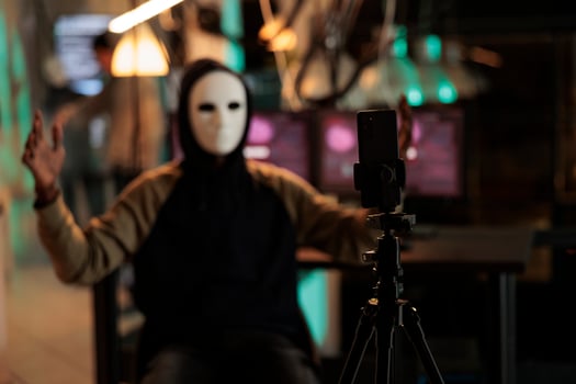 Mobile phone recording internet thief threat video, ransomware attack, anonymous threatening victim. Online scam, cyberattack, cybercrime fraud, malicious software sending photo