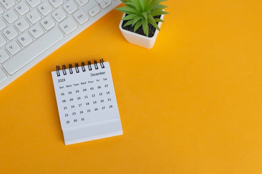 December 2024 desk calendar on yellow background. Directly above. Flat lay. photo