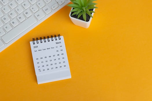 March 2024 desk calendar on yellow background. Directly above. Flat lay. photo